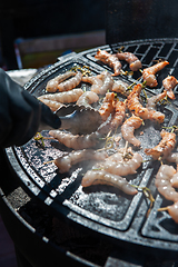 Image showing A professional cook prepares shrimps