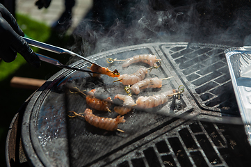 Image showing A professional cook prepares shrimps