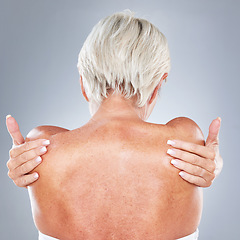 Image showing Skincare, health and back of senior woman in studio on gray background for beauty, body care and spa. Healthy skin, wellness and old woman with hands on shoulders, hugging and embrace natural body
