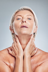 Image showing Face, skincare and beauty with a senior woman in studio on a gray background for wellness or natural treatment. Portrait, skin and luxury with a mature female posing to promote a cosmetic product