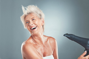 Image showing Hair, hairdryer and senior woman in studio for beauty, stylish and hair care on grey background mockup. Grey hair, mature woman and elderly woman wellness model dry hair, happy, relax and having fun