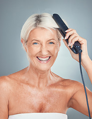 Image showing Portrait of an old woman in studio with a hair iron for grooming, hair care treatment and salon hairstyle. Beauty, self care and happy elderly person hairdressing with a hair straightener for shine