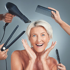 Image showing Hair care, excited and senior woman with hairdresser for beauty, haircut and preparation on grey studio background. Happy, smile and surprise face of an elderly model with hands of stylist for hair