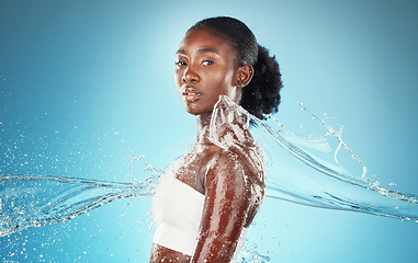 Image showing Black woman, water and cleaning body for health, skincare and beauty against blue mockup studio background. Splash, cosmetics and model with water splash for washing skin and wellness with mock up
