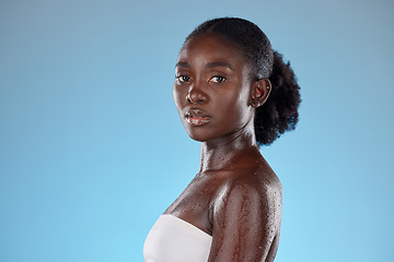 Image showing Face, beauty and skincare with a model black woman wet in studio on a blie background with mockup. Portrait, wellness and luxury with an attractive young female posing to promote hydration or health