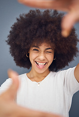 Image showing Comic, goofy and woman with hands for frame for marketing, creative and funny against a grey studio background. Happy, comedy and portrait of a girl sticking out tongue with a smile for a crazy photo