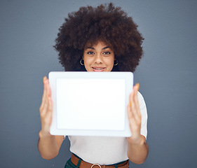 Image showing Tablet, mockup and display with a black woman in studio on a gray background for advertising or marketing. Space, product placement and technology with a female showing a blank screen for copyspace