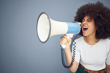 Image showing Studio, megaphone and angry black woman shouting and protesting for change, freedom or democracy. Loudspeaker, bullhorn and speech of young female using voice, screaming in protest for justice.