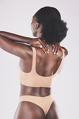 Image showing Beauty, back and lingerie by black woman in studio for skincare, grooming and hygiene on a grey background. Wellness, girl and nigerian model relax with pamper, massage and skin treatment with mockup