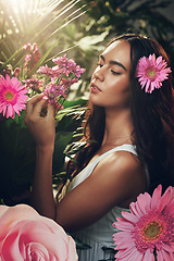 Image showing Flowers, gardening and woman in a forest, nature or park for peace, zen or wellness. Spring, plants and model in a garden with an aster flower and floral natural environment with trees in summer