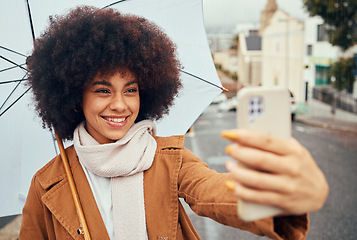 Image showing Selfie, smile and woman with a phone and umbrella during winter in the street of Australia. Video call, 5g communication and girl with a mobile photo and live streaming in the street during rain