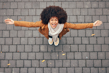 Image showing Rain, happy and woman in city during winter standing outdoor in town with smile and joy. Happiness, freedom and excited girl from Mexico with an afro enjoying the drops of water outside in urban area