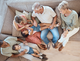 Image showing Interracial family, fun and sofa in a home living room with a happy mom, grandparents and children. Top view of happiness, smile and kids bonding with elderly people, mother and dad on a house couch