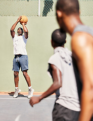 Image showing Fitness, basketball and basketball player shooting in a training game, sports exercise or workout outdoors. Wellness, focus and healthy men enjoy playing on a basketball court as friends in Nigeria