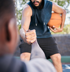 Image showing Hands, basketball and help with a man athlete and rival playing a competitive game on a sports court. Team, exercise and assistance with a basketball player helping a friend during a match outside