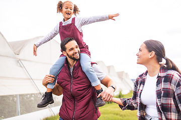 Image showing Child, mother and father holding hands on a farm as a lovely and supportive happy family farming in Colombia. Smile, dad and woman with a young girl or kid enjoying quality time, walking and bonding