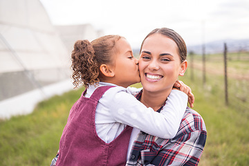 Image showing Mother, kiss and girl on a sustainability, agriculture and ecology farm with family love and care. Portrait of a mama and kid on a eco friendly, clean energy and green farming countryside with smile