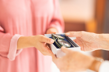 Image showing Optometry, eyewear and woman with glasses in a box after shopping in a retail optical store. Closeup of an optometrist helping a patient with her new spectacles in a case at an optics shop or clinic.