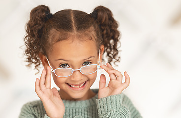 Image showing glasses, child face and eye care for vision in optometrist office. Excired young girl, happy and smile for eye exam, eyes healthcare treatment and optometry lens fashion portrait for wellness support