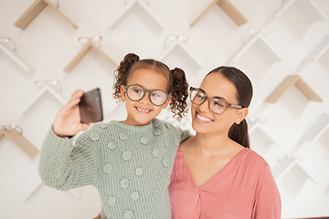 Image showing Phone, mother and child take a selfie at optometrist in new glasses after shopping for a family discount. Smile, mom and happy girl buying new frames for better eyesight or vision at a retail store