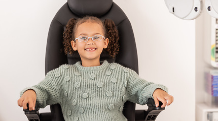 Image showing Girl child, eye test glasses and smile in portrait at optometrist office, clinic or hospital for visual impairment. Young, female kid sitting or examination of eyes, sight and vision at optical exam