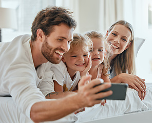 Image showing Happy family, selfie and smartphone in bedroom together for love, care or relax in family home in morning. Smile parents, excited children and cellphone of digital photo, fun and happiness lifestyle