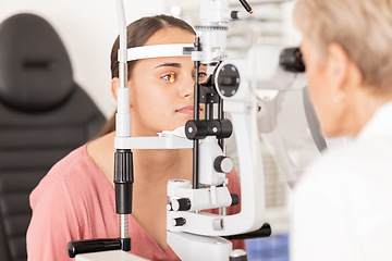 Image showing Eye, optometrist and eye exam in ophthalmologist office with optical machine to examine vision weak iris, pupil or lens of eyeball. Woman, optical clinic test and professional optician eye care test