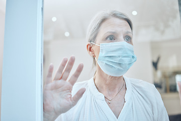 Image showing Senior woman, covid and face mask with hand on window for anxiety, mental health and safety in house during retirement. Lonely female at, home during covid 19 lockdown for government compliance