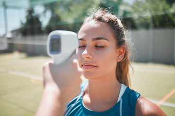 Image showing Ftiness, sports and thermometer of a woman athlete before a match or game on the court. Temperature, safety health and wellness of a strong and active woman before exercising in sport training.