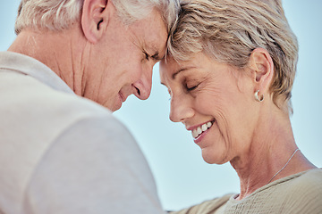 Image showing Senior, couple with forehead touch and smile for love with care, bonding and retirement outdoor. Elderly man, woman and happy for romance closeup with embrace, happiness and face to face in summer