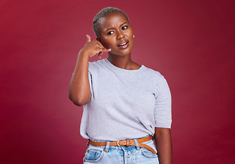 Image showing Black woman, annoyed and hand phone call sign by studio background for question, communication or network. Model, woman and call me symbol with frown while frustrated, thinking or confused in tech