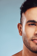 Image showing skincare, beauty and face of man in studio portrait on blue mock up for healthcare, wellness and skin glow marketing, advertising or promotion space. Young model cosmetics mockup for beard skin care