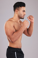 Image showing Boxing, fight and man training for a competition, event or match against a grey studio background. Fitness, exercise and focus boxer with motivation, muscle and power in fist for a fighting sport