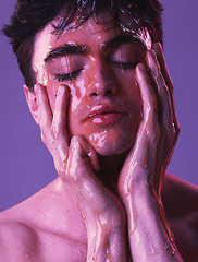 Image showing Model, man and skincare with honey dripping on face, cosmetics and organic beauty by purple backdrop. Skin, cosmetic and facial with natural moisturizer for exfoliate for health, wellness and glow