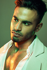 Image showing Fashion, green light and man in studio isolated on a green background. Neon light, beauty and aesthetic of male model from India in designer jacket thinking, contemplating and posing in cool clothing