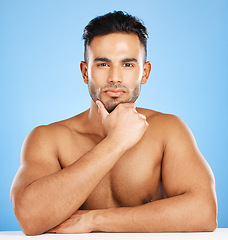 Image showing Portrait, muscular man and health for wellness, skincare and hygiene with blue studio background. Athlete male, bodybuilder and happy for body care, workout and content with motivation and fitness.