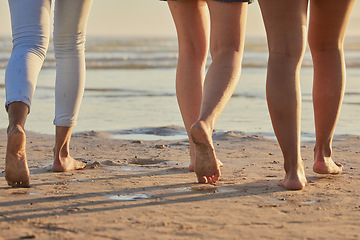 Image showing People feet, sand and walking on beach steps in summer vacation, holiday and sea travel together outdoors. Closeup group of friends, people and legs, foot and relax on ocean shore, freedom and calm