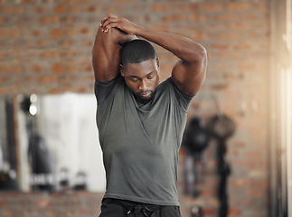 Image showing Exercise, stretch and man at gym for training, health and wellness against a brick wall background mockup. Fitness, stretching and sport guy with relax mindset before workout, cardio and performance