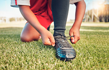 Image showing Sports, football field and child tie shoes for match workout, challenge contest or practice exercise on grass pitch. Athlete fitness health, training black kid or youth soccer player ready for game