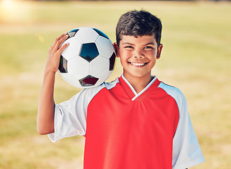 Image showing Boy portrait, field and soccer ball with smile for sport, fitness or training at soccer game, contest or competition. Athlete kid, football and happy with ball on shoulder for sports outdoor on grass