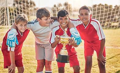 Image showing Football, teamwork and sports with trophy and children at goal post for winner, happy and fitness. Exercise, success and award with soccer player celebration for workout, training and champion