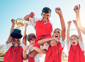 Image showing Soccer, celebration and kids team with trophy on soccer field, happy and excited at winning game. Sports, boy children goal and success in teamwork at football with gold medal award with winner smile