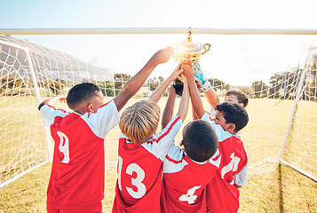 Image showing Children, winner and team soccer with trophy celebrating victory, achievement or match on the field. Kids in celebration for teamwork, sports and football match or game win together in the outdoors