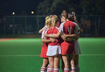 Image showing Huddle, soccer teamwork or football women on soccer field or stadium at night for support, motivation or workout game. Fitness, wellness or sports health trust, game partnership or planning on field