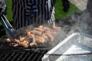 Image showing A professional cook prepares shrimps