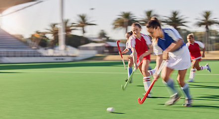 Image showing Sports, hockey and women in action on field playing game, match and training in outdoor stadium. Fitness, exercise and blur of female athletes running with speed for victory, winning and score goal