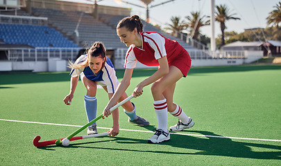 Image showing Sports fitness, field hockey game and women challenge for ball in stadium competition, club rival match or tournament contest. Training exercise, workout and athlete battle action on arena turf pitch