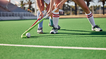 Image showing Hockey, field and athletes playing a game at a championship or sports training at an outdoor stadium. Fitness, action and team with sticks and a ball doing a exercise or skill on a sport turf court.