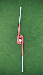 Image showing Hockey, sticks and ball on turf grass at a stadium for a sports match, exercise or training. Fitness, workout and sport equipment on outdoor field for championship game, practice or skill development