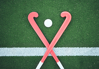 Image showing Turf field, hockey stick or sports ball on the ground for fitness competition, exercise contest or practice match. Green pitch, astroturf or cross of game equipment on the floor for training top view